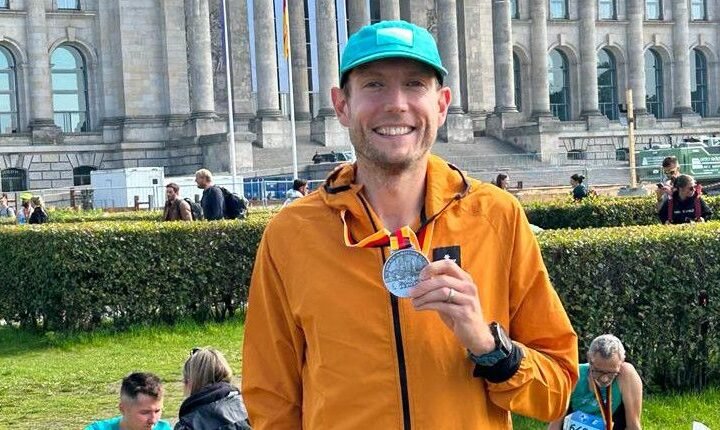 Nick Harris-Fry holding a Berlin Marathon finisher&rsquo;s medal